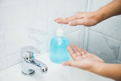 Close-up of hand holding glass bottle