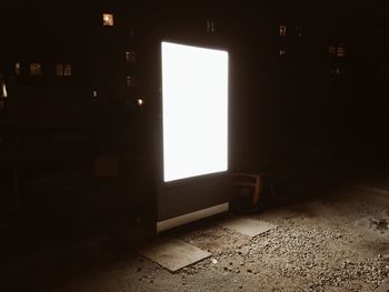 Illuminated blank billboard in dark at night