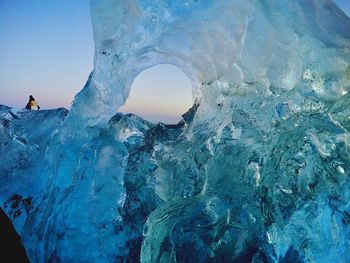 Frozen sea against sky