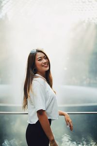 Portrait of smiling young woman standing outdoors