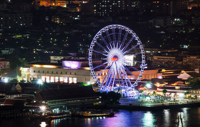 Illuminated ferris wheel at night