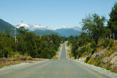 Road amidst trees against sky