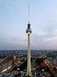 Tower amidst buildings in city against sky