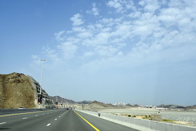 Surface level of highway against sky