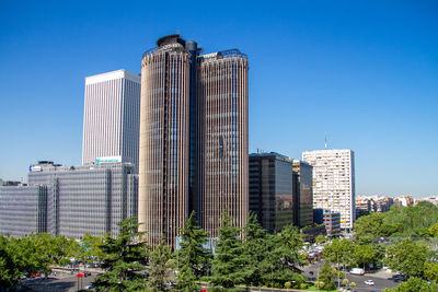 Modern buildings against clear blue sky