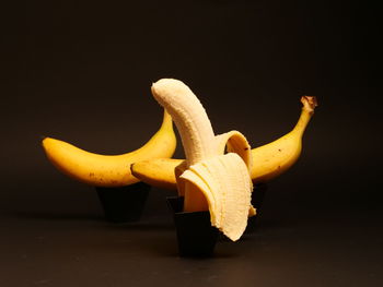 Close-up of yellow fruit on table against black background