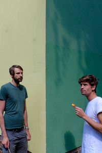 Two young men eating outdoors