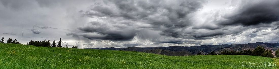 Panoramic shot of storm clouds over field