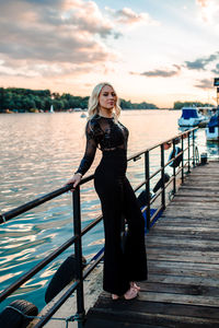 Portrait of woman against railing against sky