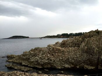 Scenic view of sea against cloudy sky