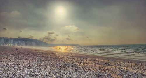 Scenic view of beach against sky during sunset