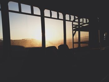 Silhouette trees against sky at sunset