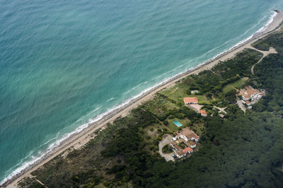 High angle view of houses by sea against sky