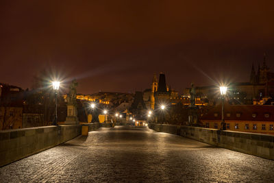 Illuminated bridge against sky at night