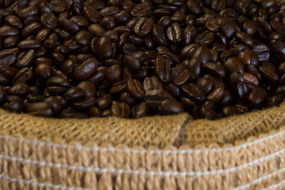 Close-up of roasted coffee beans in sack