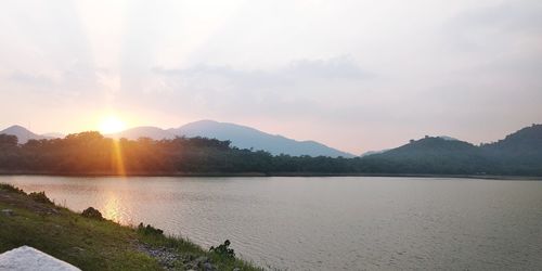 Scenic view of lake against sky during sunset