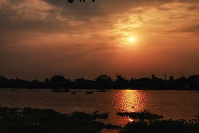 Scenic view of lake against romantic sky at sunset