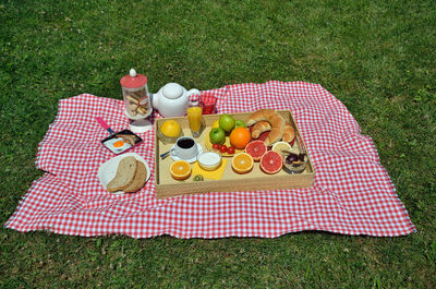 Picnic breakfast or brunch with fresh coffee, ham and egg,  croissants, cookies, orange juice