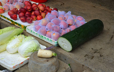 Giant cucumber next to some apples in yangshuo, china