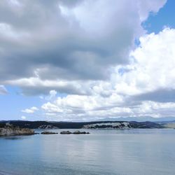 Scenic view of sea against cloudy sky