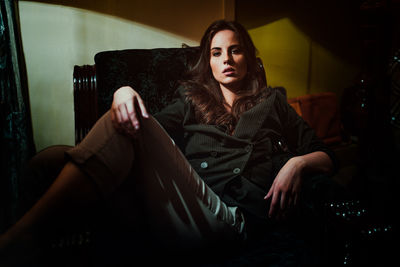 Young woman looking away while sitting at home