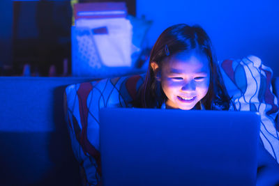 Young woman using laptop at home