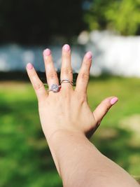 Close-up cropped woman wearing rings during sunny day