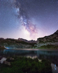 Scenic view of lake against sky at night