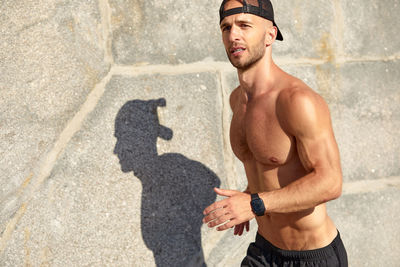 Low section of man standing on street