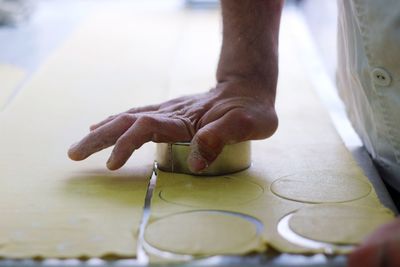 Chef cutting dough to prepare pasta