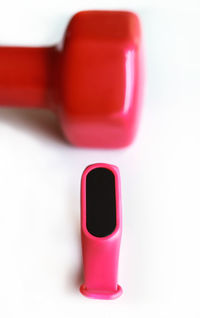 Close-up of pink flower on table against white background