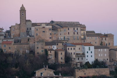 Buildings in city against clear sky