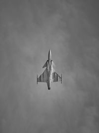 Fighter flying straight up in black and white