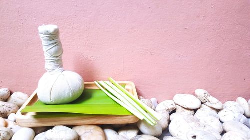 Close-up of fresh vegetables on table against wall