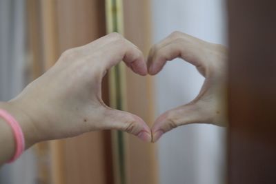 Close-up of woman hand with heart shape