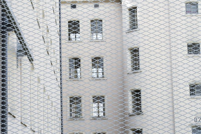 Full frame shot of chainlink fence against building