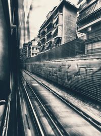 Railroad tracks amidst buildings in city