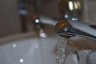 Close-up of faucet in water