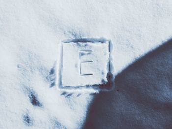 High angle view of text on snow