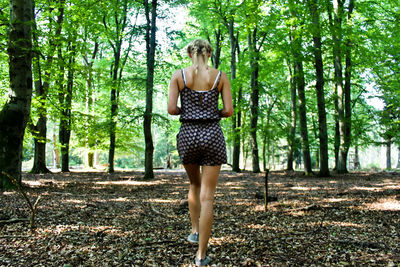 Rear view full length of woman at forest