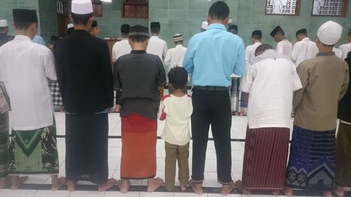 Rear view of people standing in front of office building