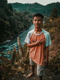 Portrait of smiling man standing on mountain