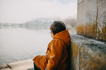 Side view of child standing at shore