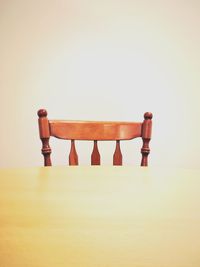 Close-up of empty chair on table against white background