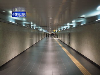 Man walking in illuminated corridor