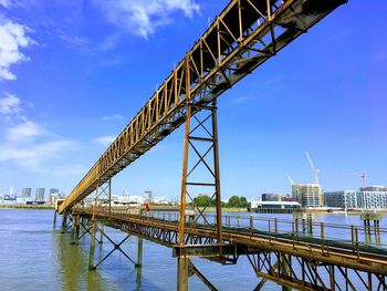 Low angle view of bridge over river against sky