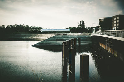 View of swimming pool by river against sky