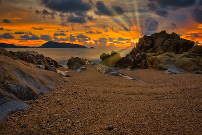 Scenic view of beach against sky during sunset