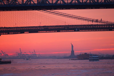 View of bridge over river during sunset