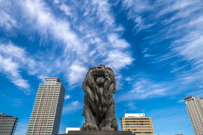 Low angle view of modern buildings against blue sky